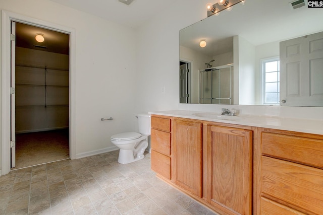 175 Nestle Ct, Columbia, SC 29209 - bathroom with a shower stall, vanity, toilet, a walk in closet, and baseboards
