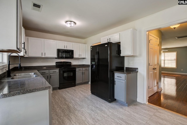 175 Nestle Ct, Columbia, SC 29209 - kitchen featuring black appliances, a sink, dark countertops, and white cabinets