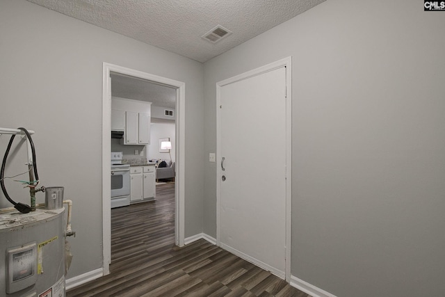 hallway featuring dark wood-style flooring, a textured ceiling, and baseboards
