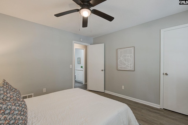 bedroom featuring dark wood-style flooring, baseboards, and a ceiling fan