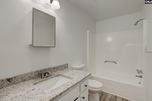 full bathroom featuring toilet, wood finished floors, shower / tub combination, and vanity