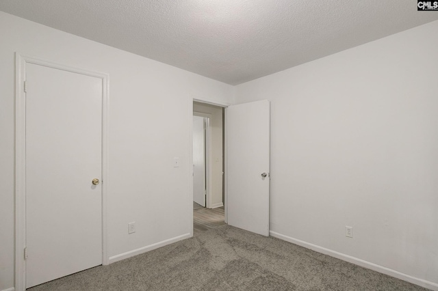 unfurnished bedroom with carpet flooring and baseboards