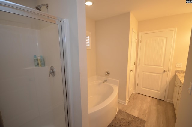 113 Judiths Path, West Columbia, SC 29072 - full bathroom featuring wood finished floors, a stall shower, a garden tub, vanity, and baseboards