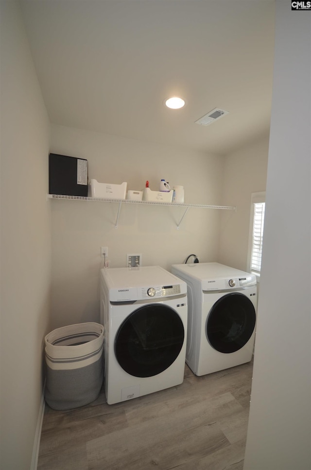 113 Judiths Path, West Columbia, SC 29072 - laundry room featuring washing machine and clothes dryer, light wood finished floors, and recessed lighting