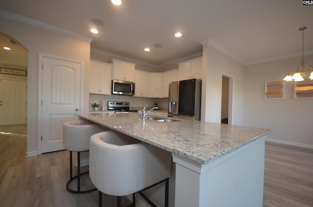 113 Judiths Path, West Columbia, SC 29072 - kitchen with appliances with stainless steel finishes, a sink, arched walkways, wood finished floors, and ornamental molding