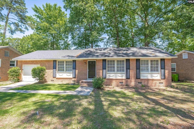 ranch-style home with crawl space, an attached garage, brick siding, and a front yard