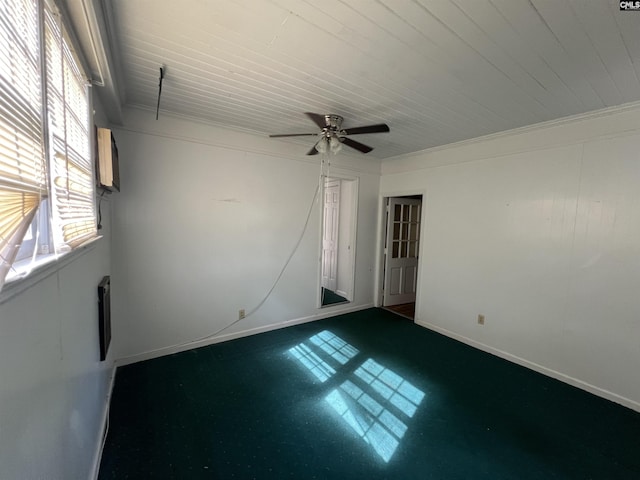 spare room with wood ceiling, ceiling fan, and baseboards