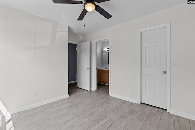 unfurnished bedroom with light wood finished floors, baseboards, connected bathroom, and a ceiling fan