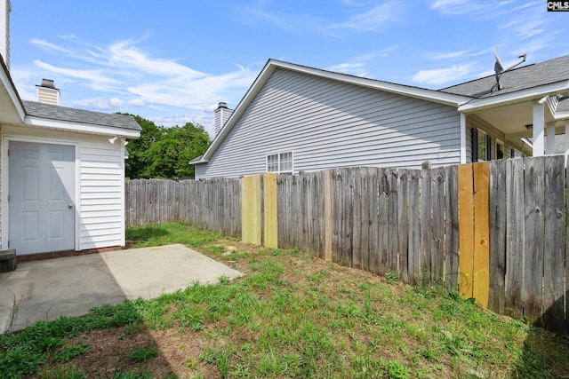 fenced backyard with a patio