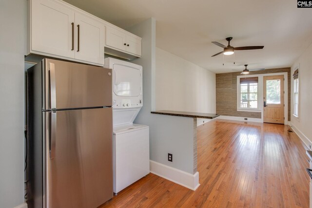 808 Oak St, Columbia, SC 29205 - kitchen featuring freestanding refrigerator, stacked washer and clothes dryer, a ceiling fan, and baseboards
