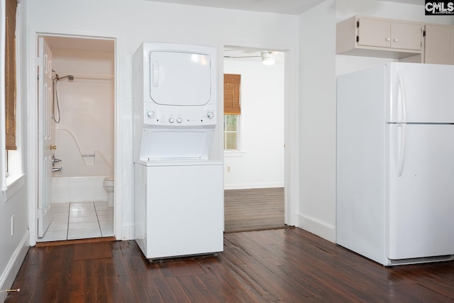 808 Oak St, Columbia, SC 29205 - clothes washing area with stacked washer / dryer, dark wood finished floors, and baseboards