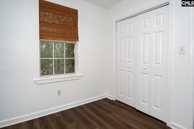 808 Oak St, Columbia, SC 29205 - unfurnished bedroom featuring dark wood-style floors, a closet, and baseboards