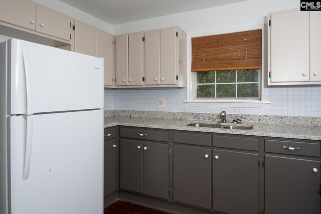 808 Oak St, Columbia, SC 29205 - kitchen with freestanding refrigerator, a sink, tasteful backsplash, gray cabinetry, and light stone countertops