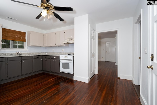 808 Oak St, Columbia, SC 29205 - kitchen featuring white electric stove, under cabinet range hood, gray cabinets, ceiling fan, and dark wood-type flooring