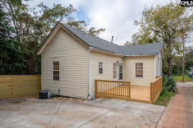 808 Oak St, Columbia, SC 29205 - rear view of house featuring a shingled roof, fence, a wooden deck, a patio area, and central air condition unit