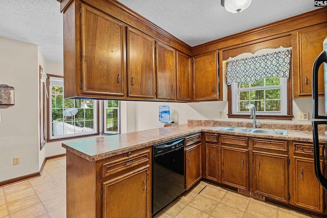 401 Brickling Rd, Irmo, SC 29063 - kitchen with black dishwasher, a sink, a textured ceiling, brown cabinets, and a peninsula