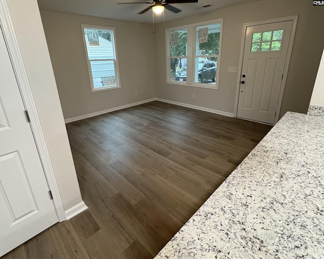 entrance foyer featuring a ceiling fan, dark wood-style floors, and baseboards