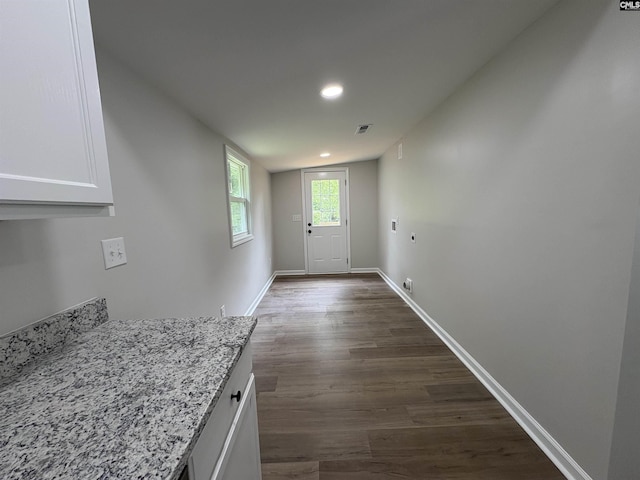 entryway featuring dark wood-type flooring, baseboards, and recessed lighting