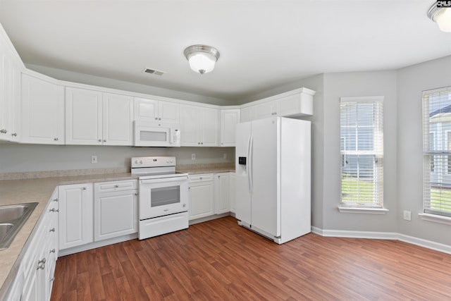 kitchen featuring white appliances, dark wood-style floors, white cabinets, and light countertops