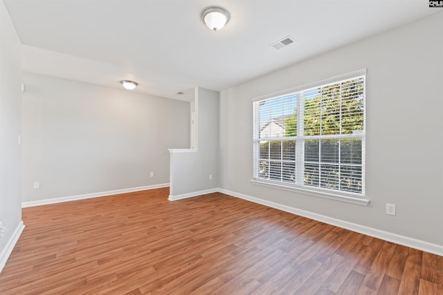 unfurnished room featuring light wood-type flooring and baseboards