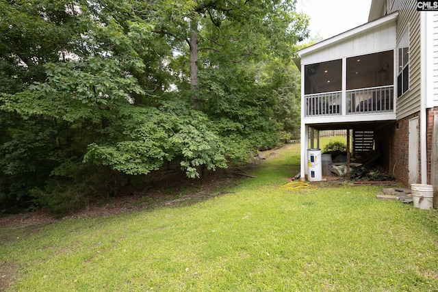 view of grassy yard with a sunroom and stairway