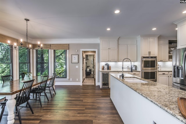 3 Puddle Ln, Camden, SC 29020 - kitchen featuring appliances with stainless steel finishes, wine cooler, a sink, baseboards, and decorative backsplash
