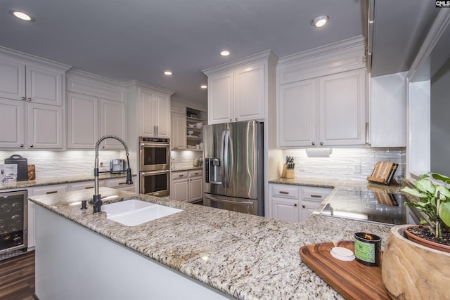 3 Puddle Ln, Camden, SC 29020 - kitchen featuring appliances with stainless steel finishes, a sink, beverage cooler, decorative backsplash, and light stone countertops