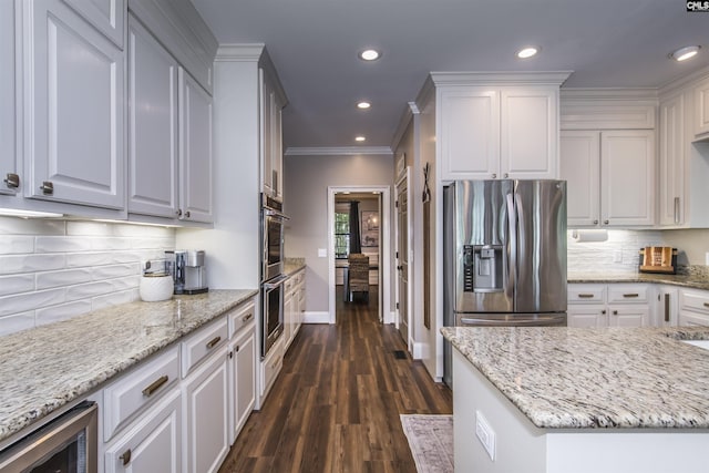 3 Puddle Ln, Camden, SC 29020 - kitchen with appliances with stainless steel finishes, beverage cooler, baseboards, light stone counters, and crown molding