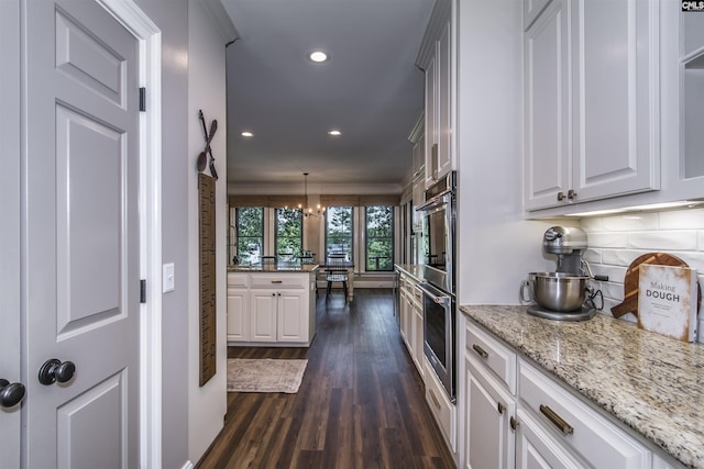 3 Puddle Ln, Camden, SC 29020 - kitchen featuring stainless steel double oven, dark wood finished floors, recessed lighting, white cabinets, and decorative backsplash