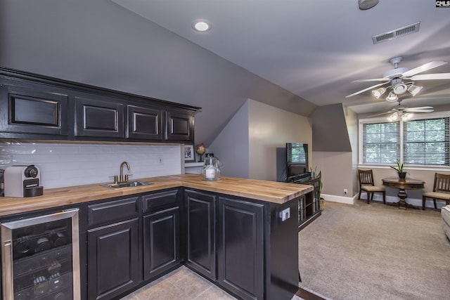 3 Puddle Ln, Camden, SC 29020 - kitchen featuring wooden counters, beverage cooler, a sink, ceiling fan, and vaulted ceiling