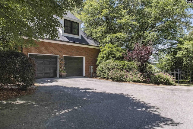 3 Puddle Ln, Camden, SC 29020 - garage with fence and asphalt driveway