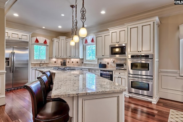 104 Preserve Ln, Columbia, SC 29209 - kitchen with built in appliances, plenty of natural light, crown molding, a kitchen island, and light stone countertops