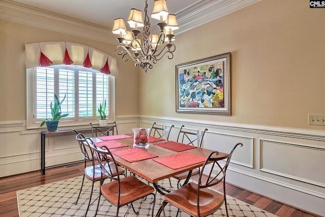 104 Preserve Ln, Columbia, SC 29209 - dining room featuring ornamental molding, a chandelier, wainscoting, wood finished floors, and a decorative wall