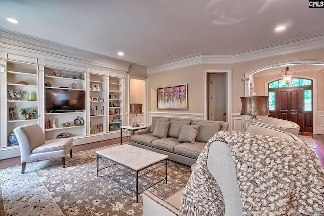 104 Preserve Ln, Columbia, SC 29209 - living room with arched walkways, ornamental molding, wood finished floors, a decorative wall, and wainscoting
