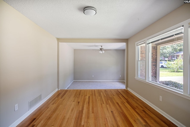 721 Seton Rd, Columbia, SC 29212 - unfurnished room featuring light wood-style floors, a textured ceiling, a ceiling fan, and baseboards