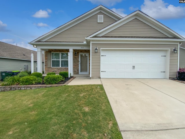 view of front of home featuring driveway, a front lawn, and a garage