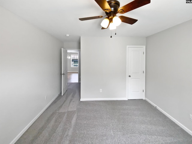 spare room featuring carpet floors, baseboards, and ceiling fan
