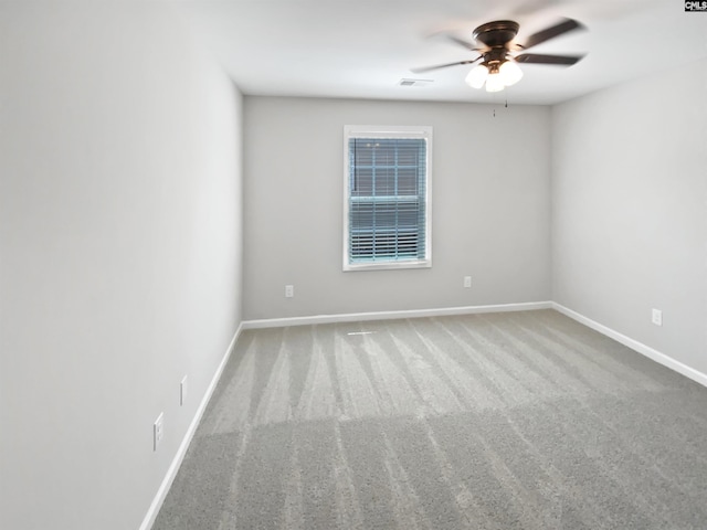 unfurnished room with a ceiling fan, baseboards, and carpet floors