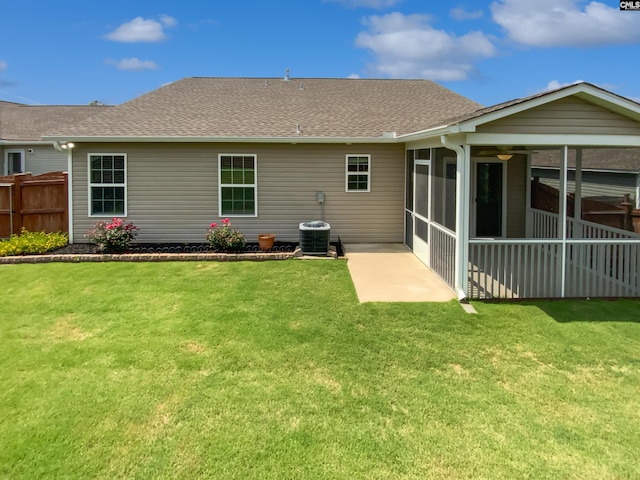 rear view of house with a sunroom, a shingled roof, central air condition unit, and a patio area