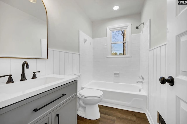 4520 Bluff Rd, Columbia, SC 29209 - full bathroom with wood finished floors, wainscoting, toilet,  shower combination, and vanity