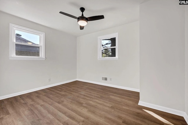 4520 Bluff Rd, Columbia, SC 29209 - unfurnished room with healthy amount of natural light, baseboards, wood finished floors, and a ceiling fan