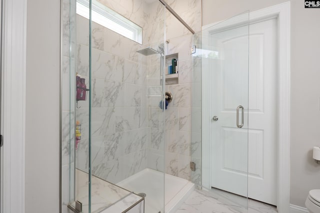 bathroom with a shower stall, marble look tile flooring, and toilet