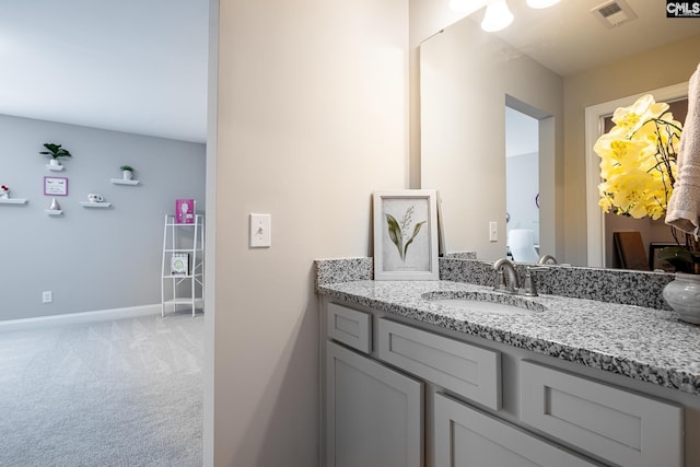 bathroom with vanity and baseboards