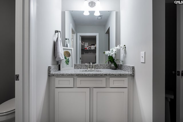 bathroom with toilet and vanity