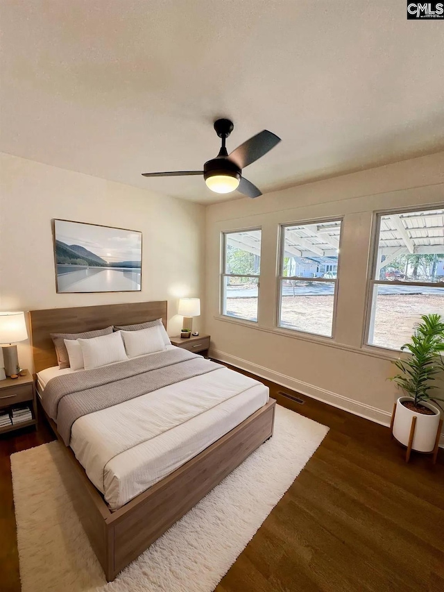 1306 Bonner Ave, Columbia, SC 29204 - bedroom with dark wood-style flooring, baseboards, and a ceiling fan