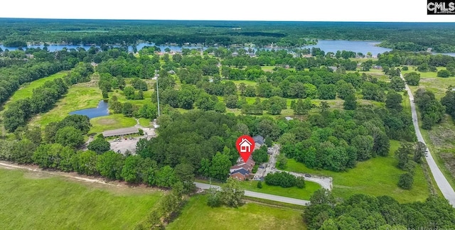 bird's eye view of a nearby body of water and a heavily wooded area