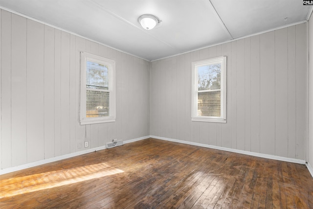 4717 Linden St, Columbia, SC 29203 - unfurnished room featuring wood-type flooring, plenty of natural light, baseboards, and wooden walls
