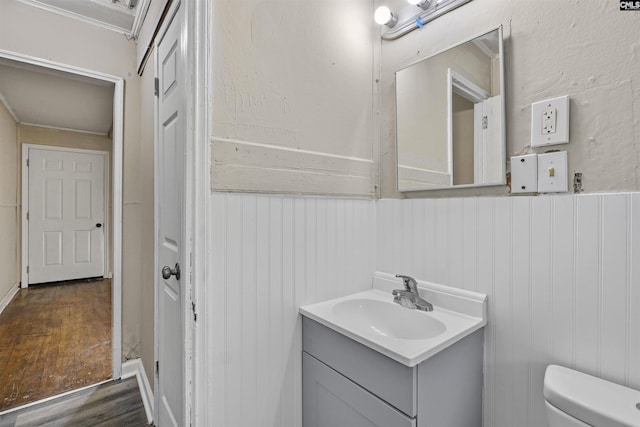 4717 Linden St, Columbia, SC 29203 - bathroom with wood finished floors, toilet, wainscoting, vanity, and ornamental molding