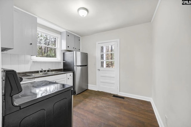322 Glenn Ave, Columbia, SC 29203 - kitchen featuring black electric range, a sink, freestanding refrigerator, dark countertops, and plenty of natural light
