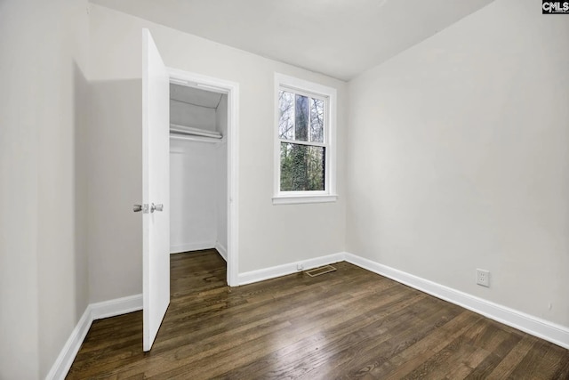 322 Glenn Ave, Columbia, SC 29203 - unfurnished bedroom featuring baseboards, dark wood-type flooring, and a closet